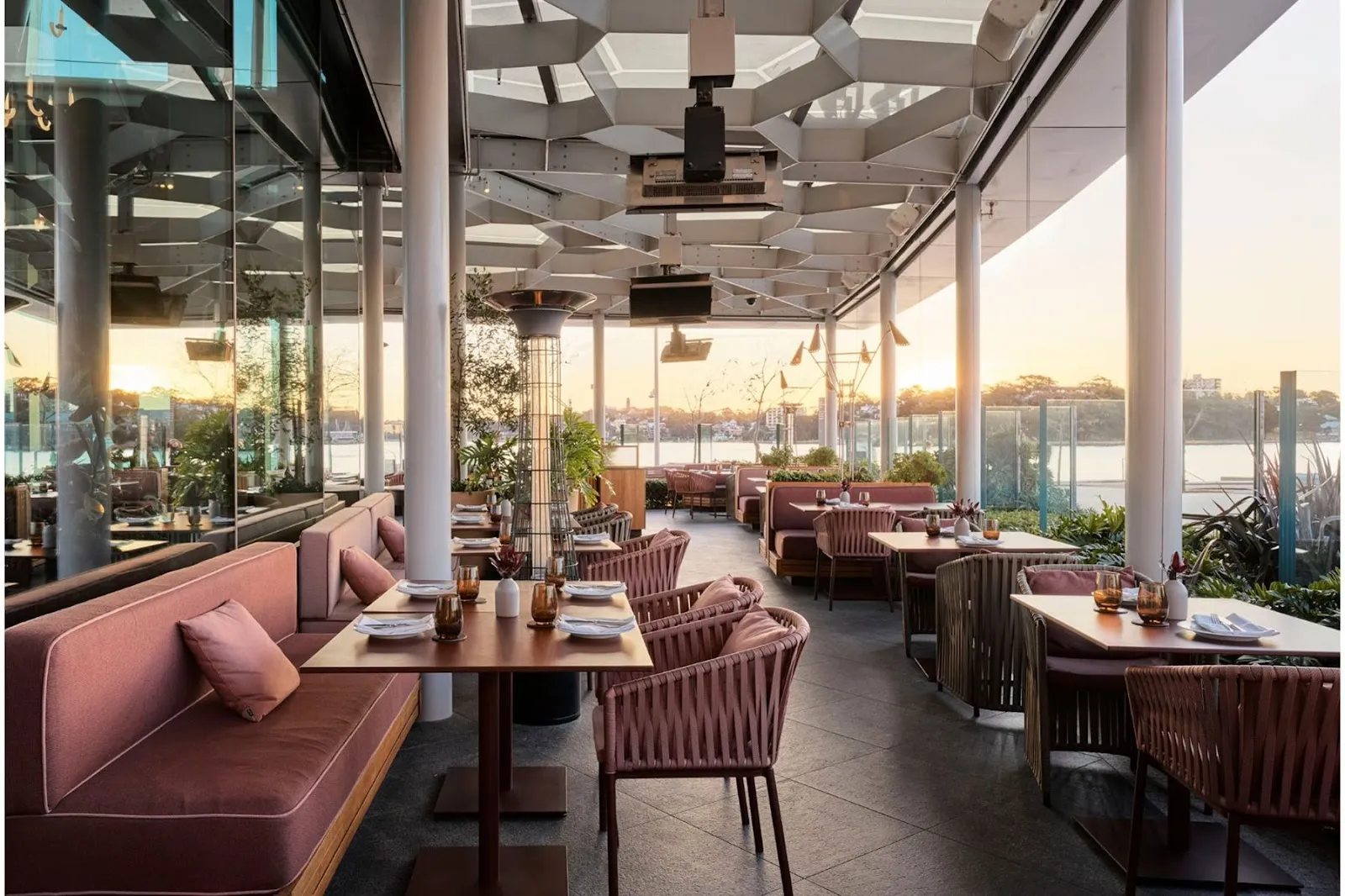 A harbour-view hotel dining room in Sydney at dusk