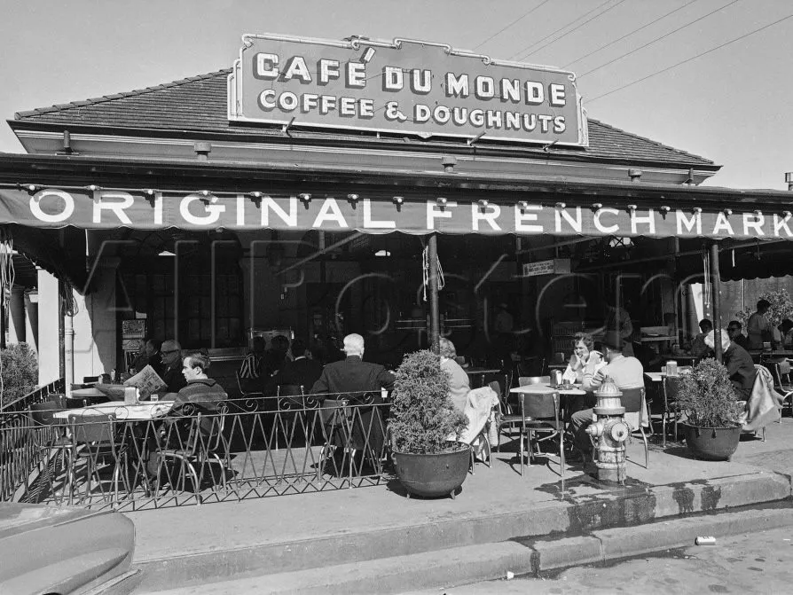 A family eating beignets at an open-air New Orleans cafe